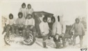 Image of Eskimos [Inuit] gathered around snowmobile donated by MacMillan [Ama Paniqniak in middle]